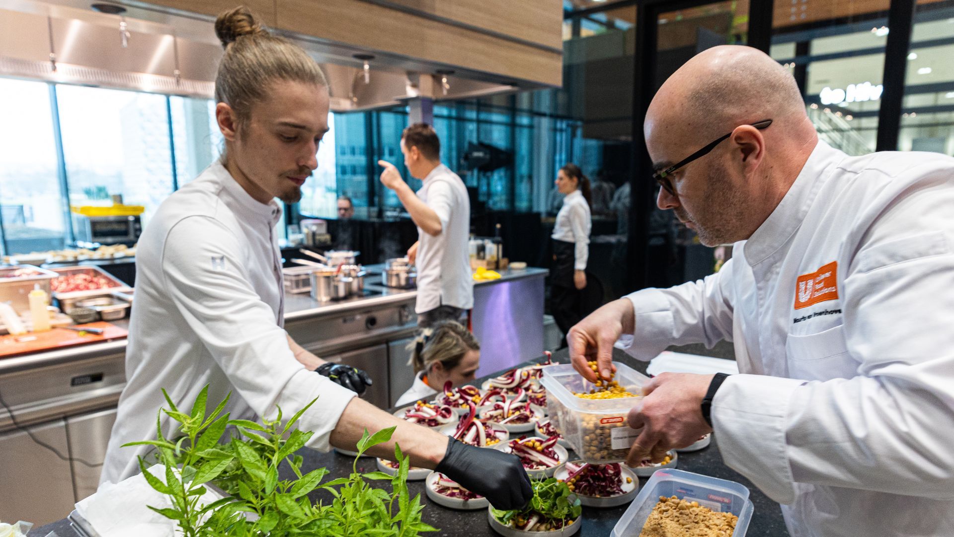 Chefs preparing dishes in a busy kitchen.