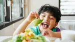 A child eating a plant-based diet